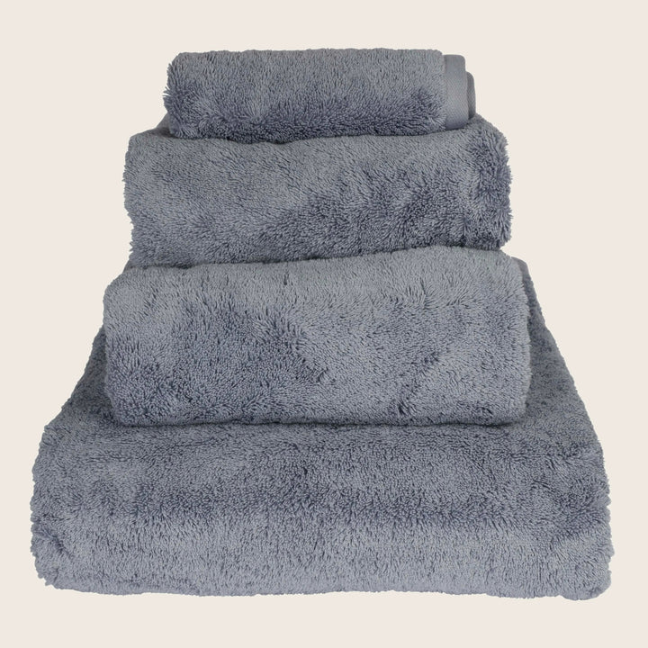 Stack of four folded gray fluffy towels in descending size