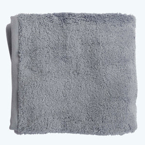 Soft, fluffy, light brown towel neatly folded on white background. - hover