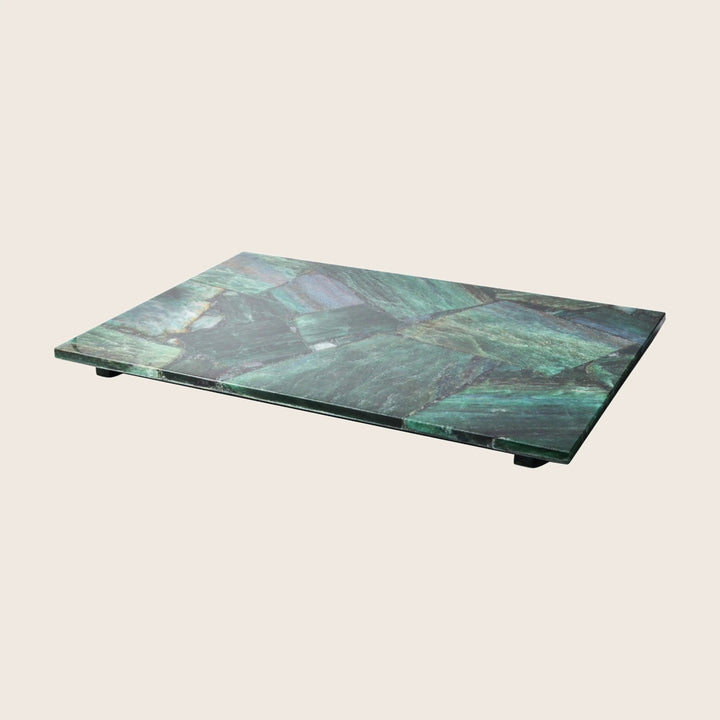 Rectangular marble slab with green hues against white background