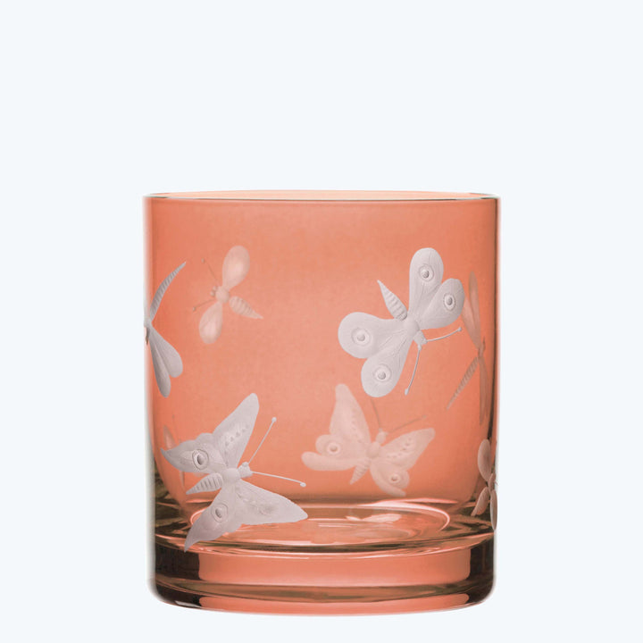 Peach-tinted glass with etched butterfly design on monochromatic background.