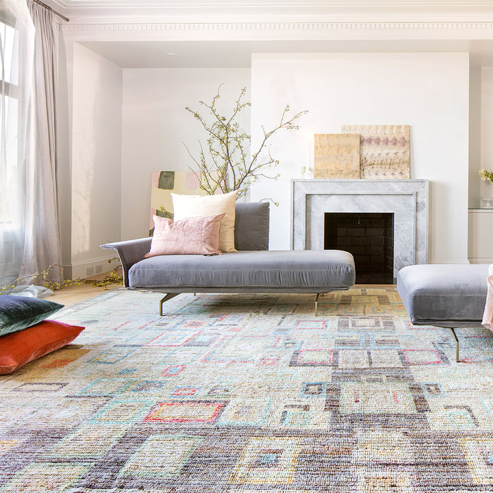 Modern living room with minimalist design, daybed, fireplace, and natural light.