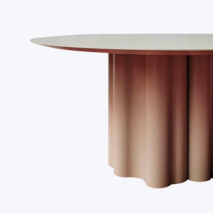 Modern oval table with unique base design in neutral and copper tones.