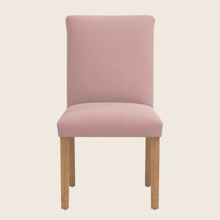 Modern pink upholstered dining chair with wooden legs, minimalist design.
