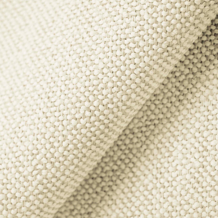 Close-up of textured fabric with raised dot weave pattern, sepia tone.