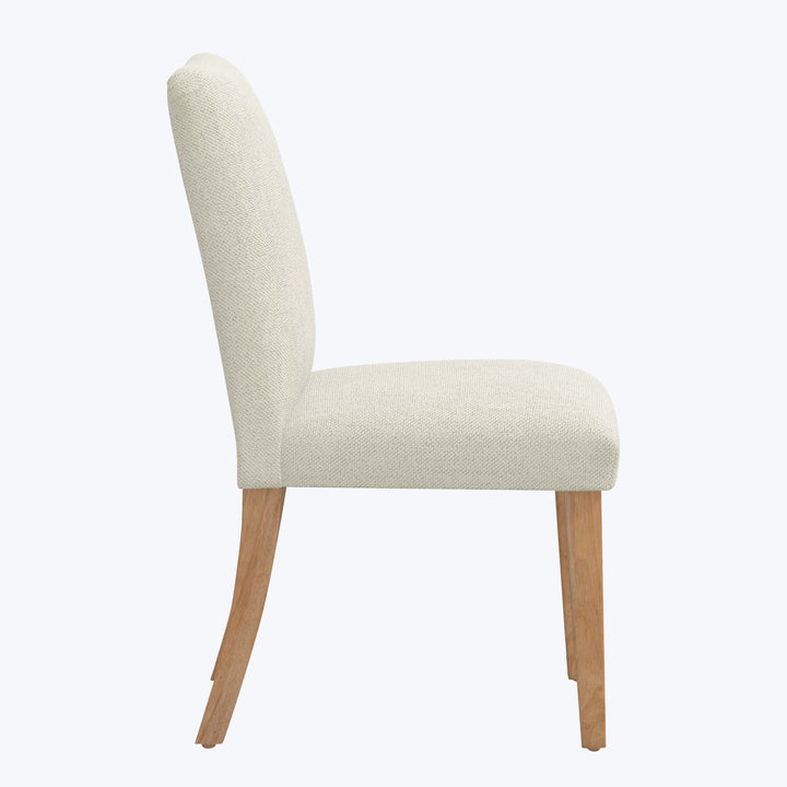 Modern dining chair with beige fabric upholstery and wooden legs.