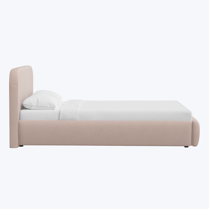 Modern minimalist bed with light beige upholstery and white bedding.