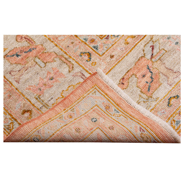 Folded oriental rug with traditional design, high-quality craftsmanship evident.