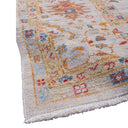 Close-up detail of ornately patterned Persian-style rug with plush pile.