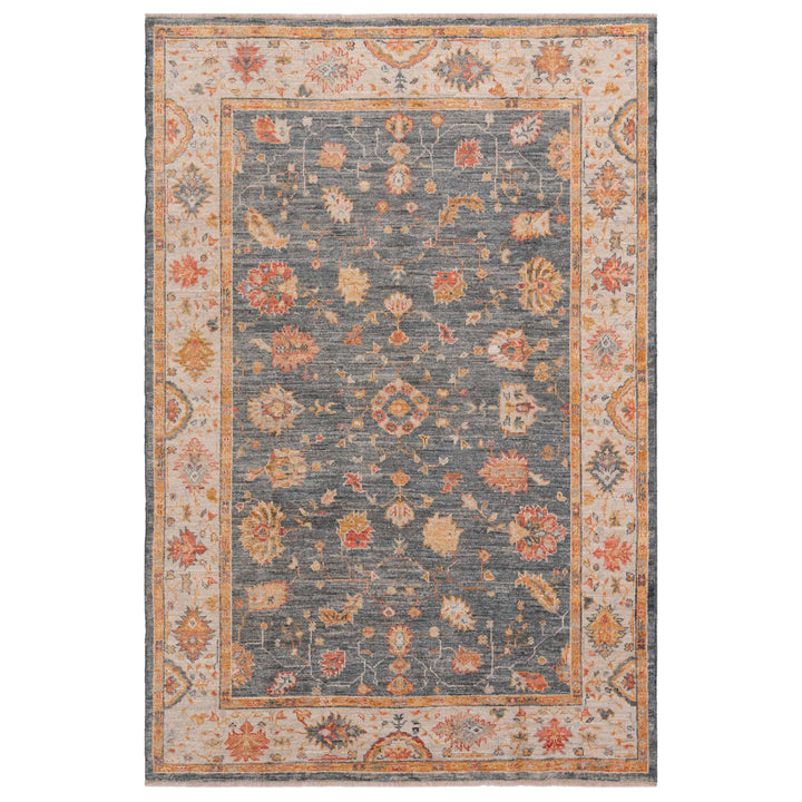 Vintage ornate area rug with detailed floral and geometric pattern.