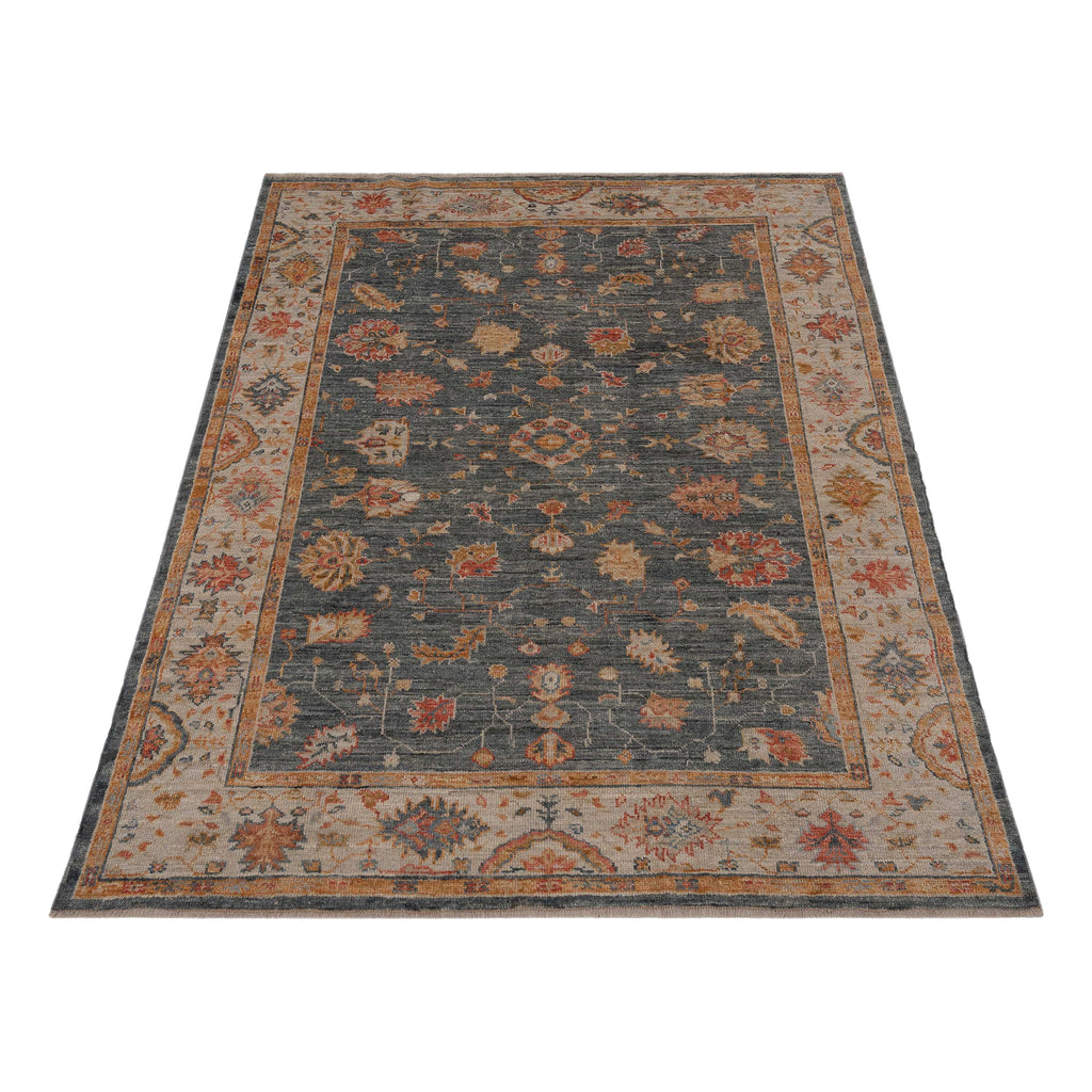 Intricate rectangular area rug with symmetrical pattern in dark colors.