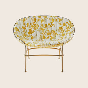 Modern golden chair with floral upholstery, sleek design for interiors.