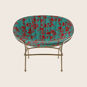 Stylish chair with floral upholstery and gold metal frame design.