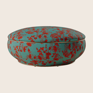 Colorful split-design cushion with floral pattern on turquoise background, versatile storage.