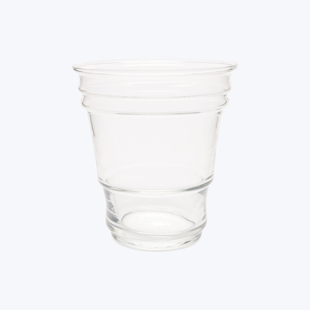 Transparent plastic cup on white background, empty with tapered design.