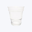 Transparent plastic cup on white background, empty with tapered design.