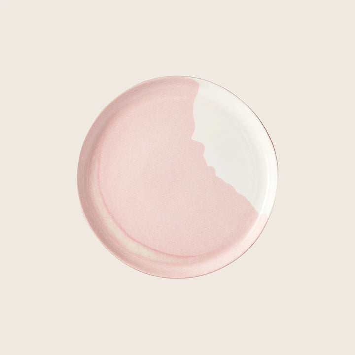 Elegant two-tone round plate with pink and white design.
