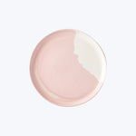Elegant two-tone round plate with pink and white design.