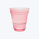 Single pink plastic cup with ribbed design on white background.