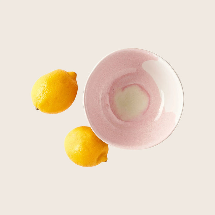 Freshly squeezed lemonade with a frothy pink twist in glass.