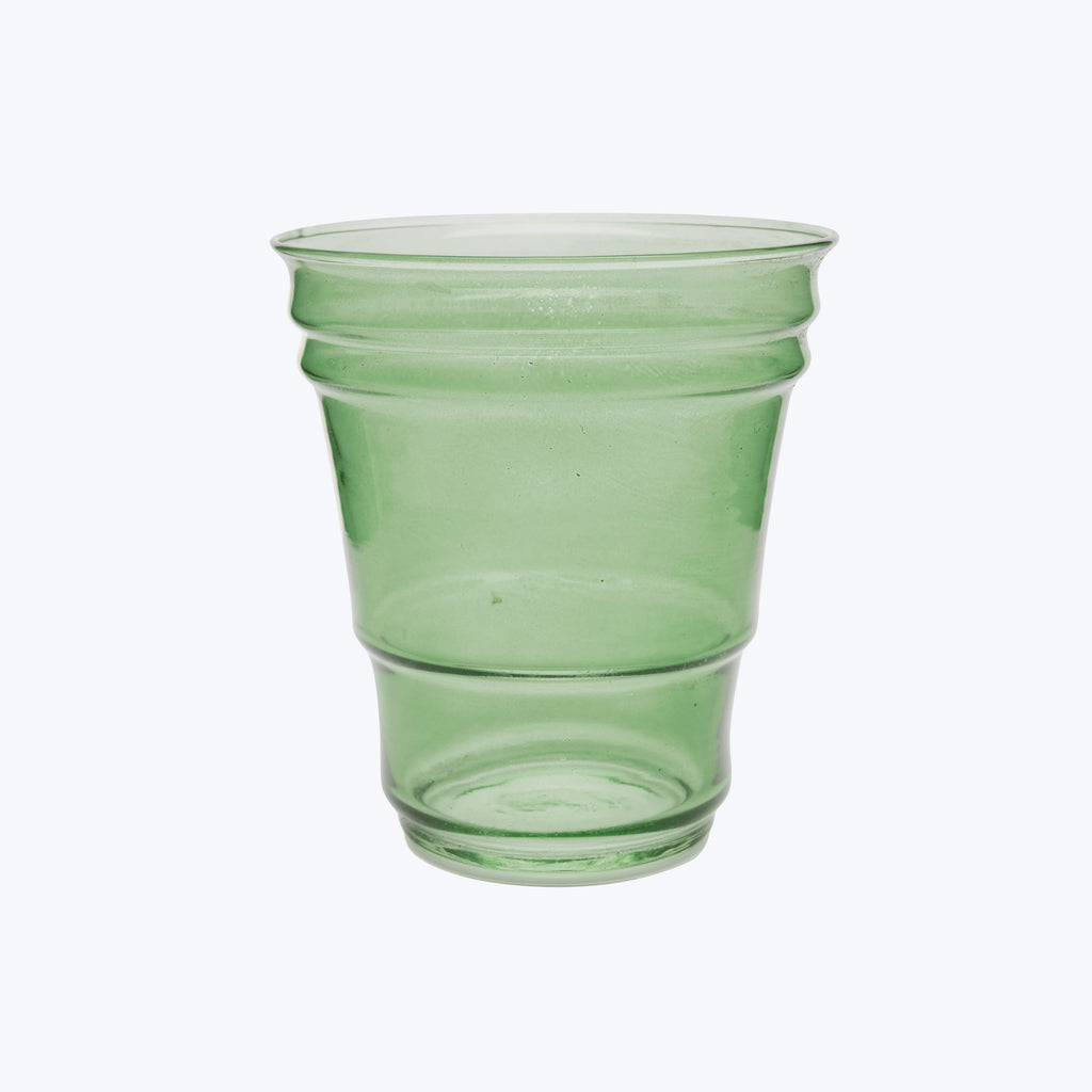 Empty green-tinted plastic cup isolated on white background, slightly textured.