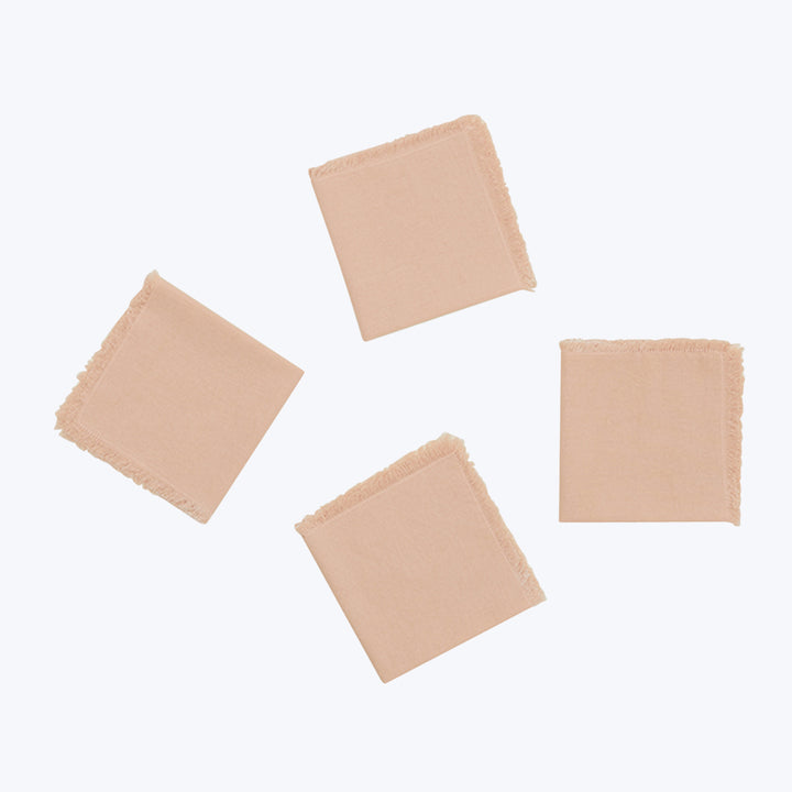 Four fabric swatches with frayed edges on neutral background.