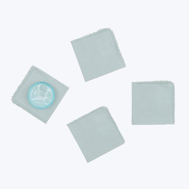 Five fabric pads in pastel colors with frayed edges.