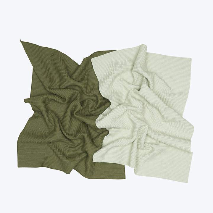 Two crumpled waffle textured fabrics in olive green and cream