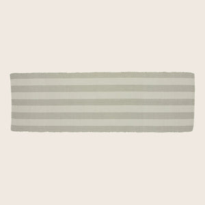 Rectangular textile object with alternating beige stripes and scalloped border.