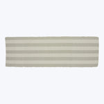 Rectangular textile object with alternating beige stripes and scalloped border.