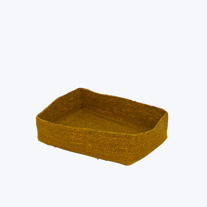 Golden-yellow woven basket with flat base against white background.