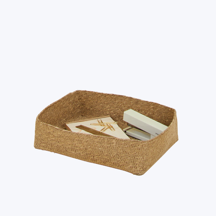 Rectangular woven basket holding clothespins and white eraser block.