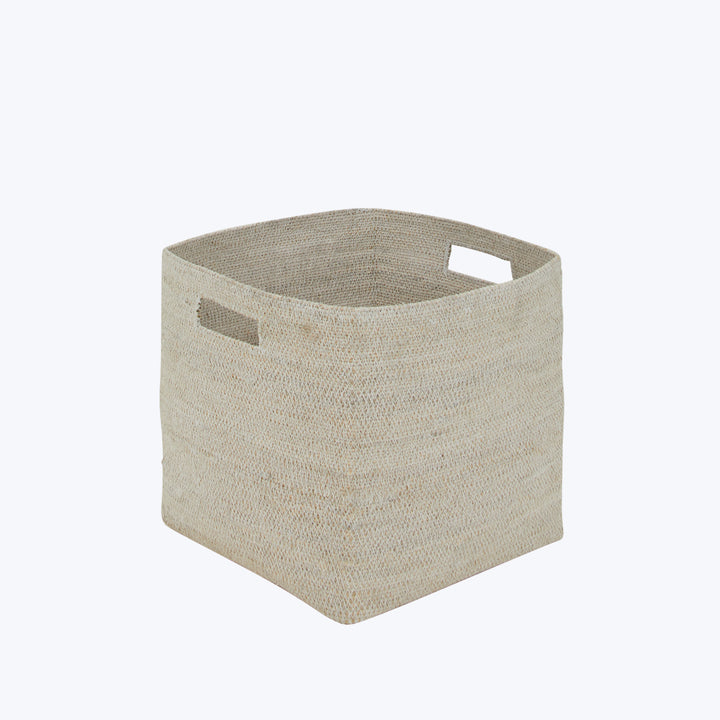 Minimalistic square storage basket in natural beige with cut-out handles.