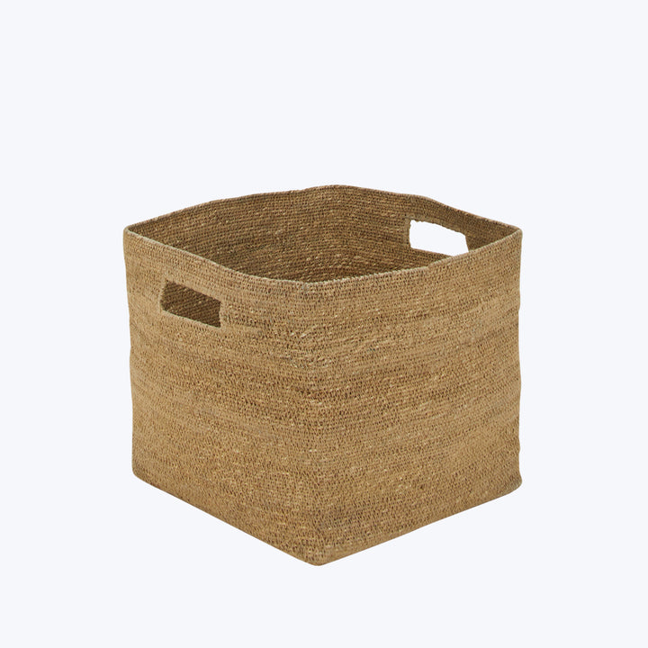 Handmade square woven basket in natural brown with side cut-outs.