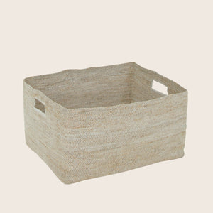 Minimalist beige woven fabric storage basket with cut-out handles.