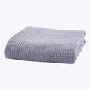 Soft lavender corduroy blanket folded neatly on white background.