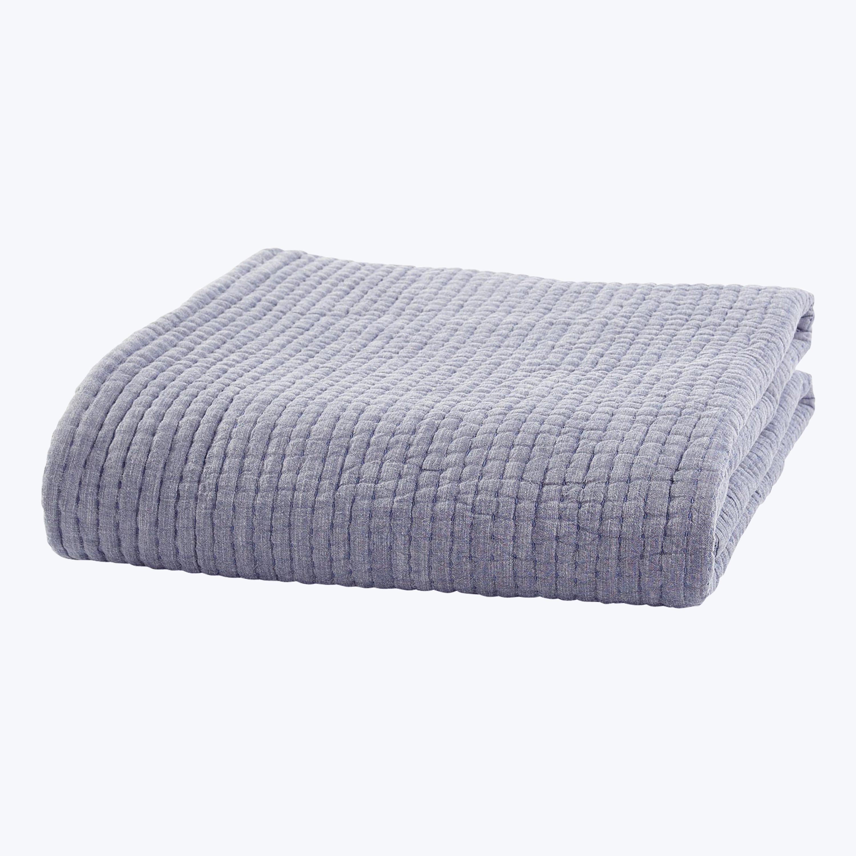 Soft lavender corduroy blanket folded neatly on white background.