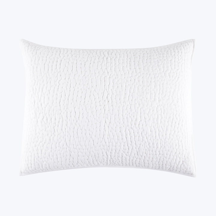 White textured pillow with raised ripple pattern on isolated background.