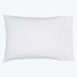 Rectangular white pillow with orange stitching detail, fluffy and decorative.