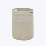 Neutral beige cylindrical fabric storage basket with cut-out handles.