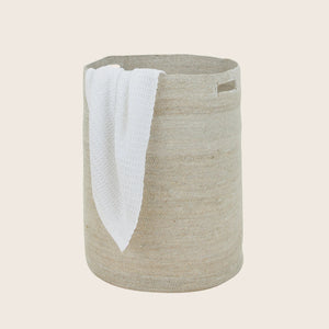 Neutral beige cylindrical fabric storage basket with cut-out handles. - hover