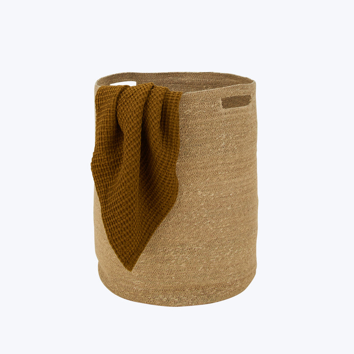 Beige waffle-texture basket with mustard blanket, home decor item.