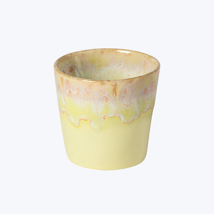 Cylindrical ceramic pot with dripping orange and beige decorative edge.