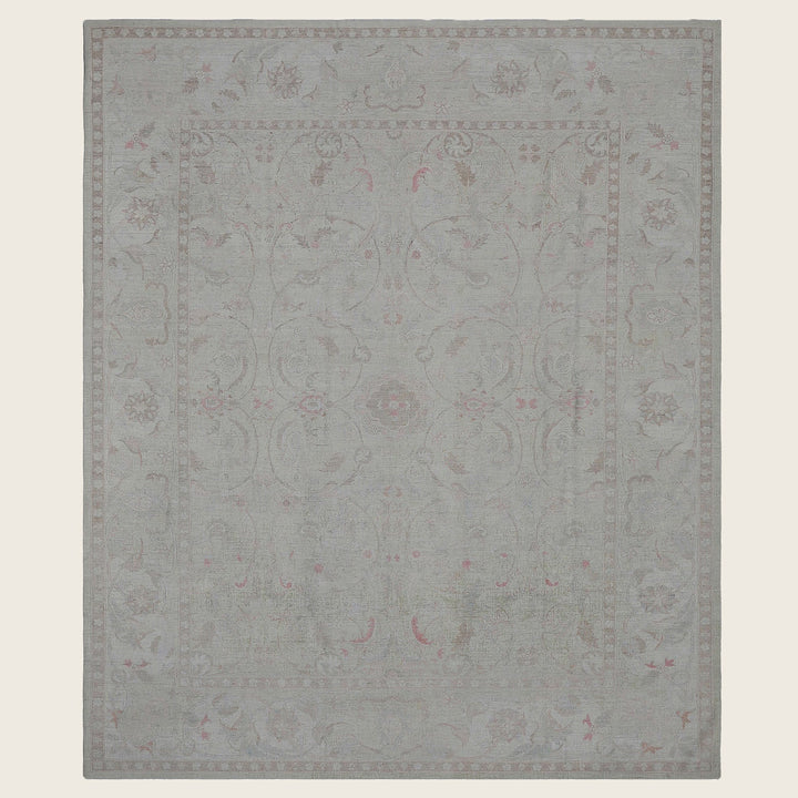 Elegant rectangular area rug with floral design in muted colors.
