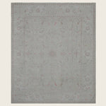 Elegant rectangular area rug with floral design in muted colors.