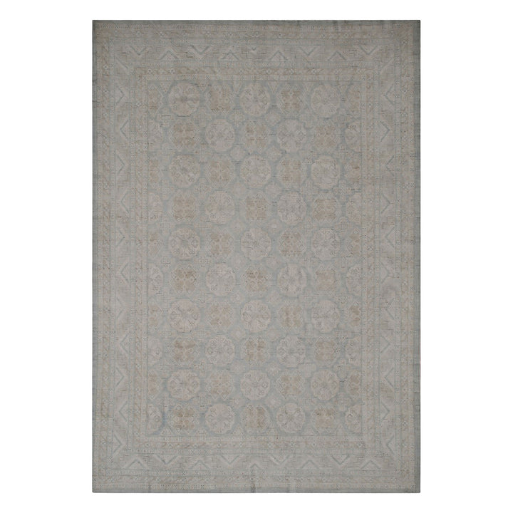 Rectangular area rug with elegant geometric and floral pattern design.