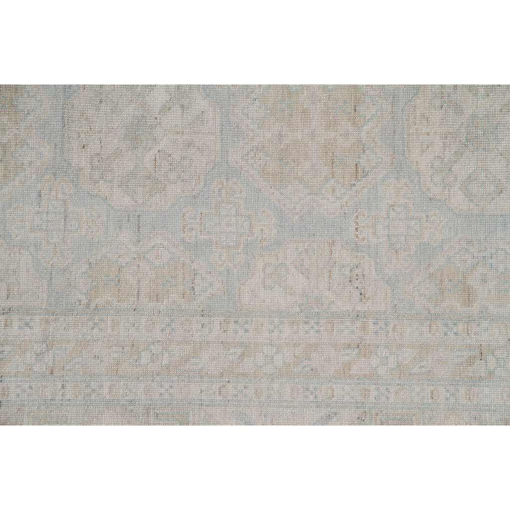 Vintage style wool blend rug with subtle geometric and floral motifs.