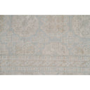 Vintage style wool blend rug with subtle geometric and floral motifs.