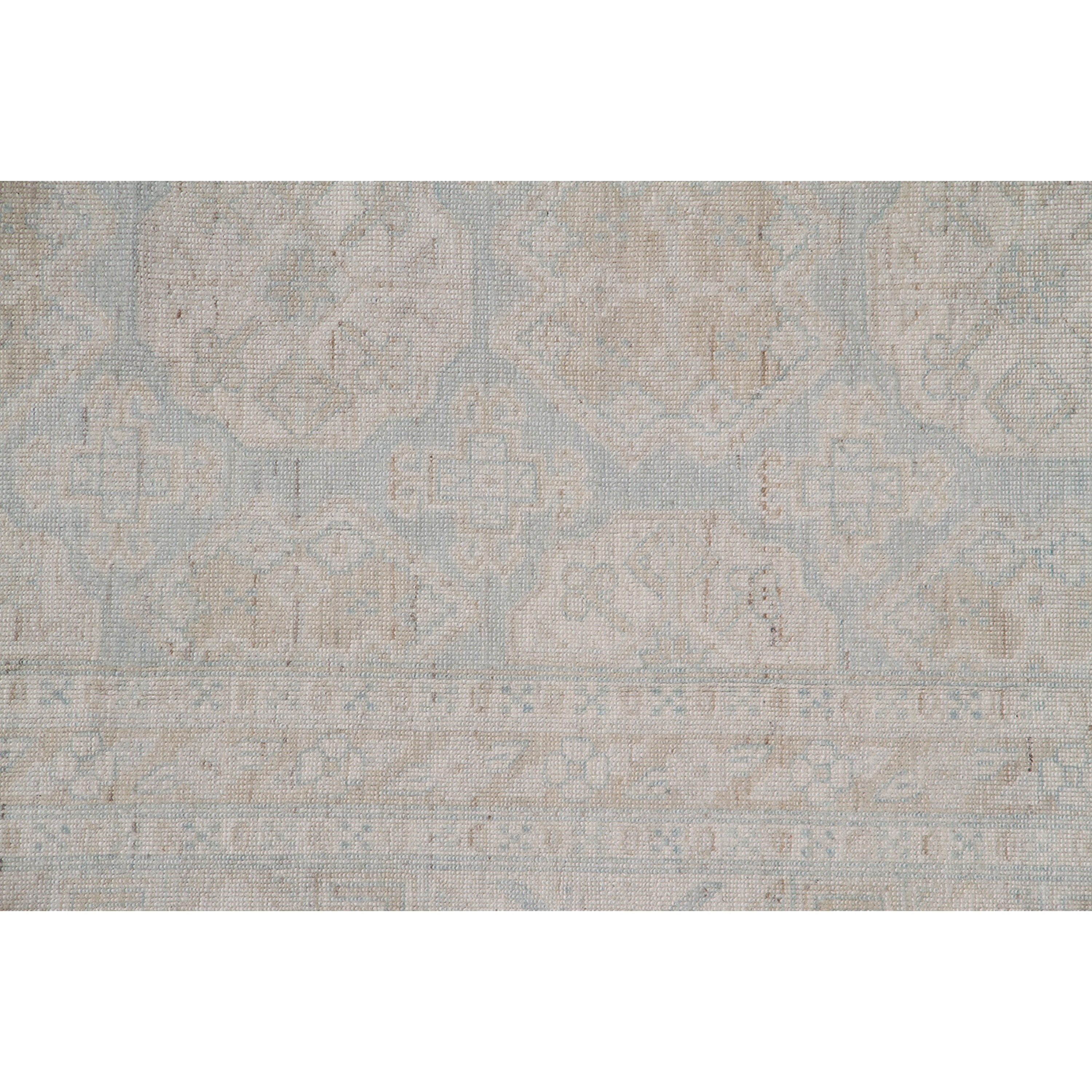 Vintage style wool blend rug with subtle geometric and floral motifs.