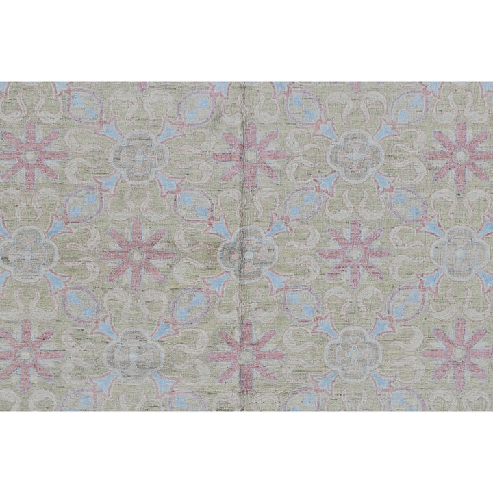 Symmetrical floral textile design in vintage style with pink and blue motifs on neutral beige background.