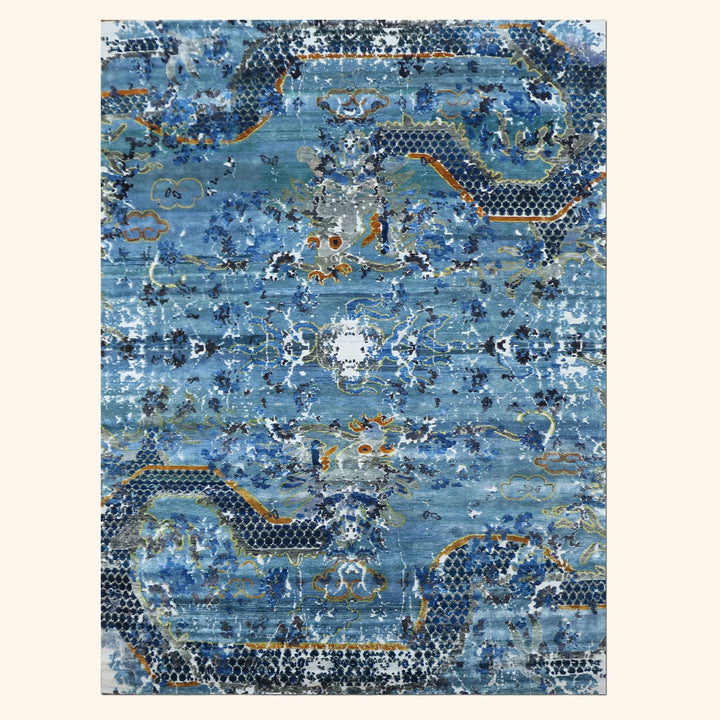 Vintage rectangular carpet with ornate blue design and aged look.